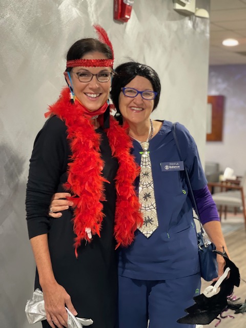 Team member smiling with patient in red scarf